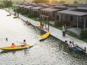 a group of people on boats in a river at มีดี ฟาร์ม โฮมสเตย์ in Ban Klam