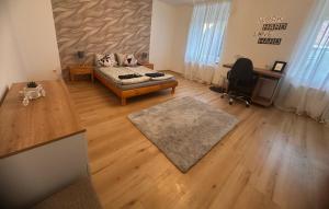 a living room with a couch and a desk at Shine Home in Klagenfurt
