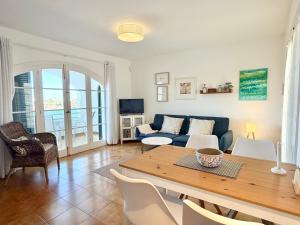 a living room with a table and a couch at White Sands 3.07 in Arenal d'en Castell