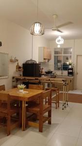 a kitchen with a wooden table and a dining room at Homestay D' Aura Pool Melaka in Ayer Keroh +9 photos