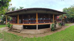 a building with a porch and a motorcycle in a yard at Noupad sunset Guesthouse in Don Det