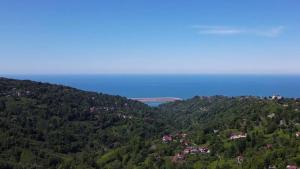 a view of a mountain with houses and the ocean at Du du Bungalov in Pazar