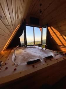 a large bath tub in a room with a window at Du du Bungalov in Pazar