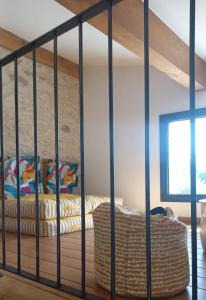 a room with a loft bed with a couch at Gite des Egadillias climatisé in Marsanne