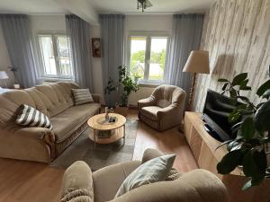 a living room with two couches and a coffee table at Apartamenty Vega in Charzykowy