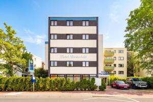 a tall building with a sign that reads fixed wednesday at Hotel Westerfeld in Hemmingen