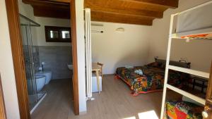 a bedroom with a bunk bed and a bathroom at Orto Raccolto in Termini Imerese