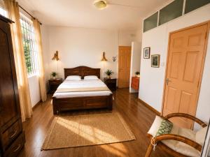 a bedroom with a bed and a couch and a door at Suntoo Villa Wind & Kitesurf Accommodation in La Gaulette +14 photos