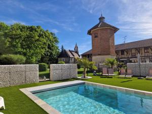 an estate with a swimming pool and a building at Gîtes du Château de Crespy in Crespy-le-Neuf