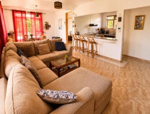 a living room with a couch and a table at Suntoo Villa Wind & Kitesurf Accommodation in La Gaulette