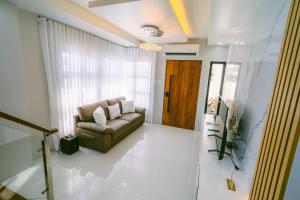 a living room with a couch and a window at Amethyst Bcd in Bacolod +18 photos