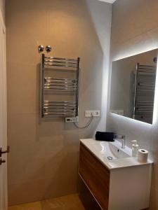 a bathroom with a sink and a mirror at Roque Home Stay in La Mata +12 photos