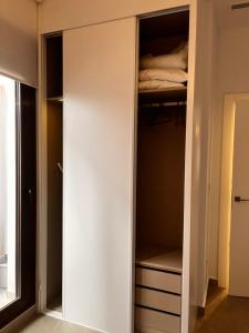 a white closet with a bed in it at Roque Home Stay in La Mata