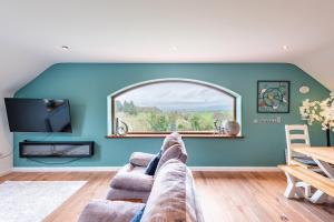 a living room with a couch and a window at Corlea Studio in Dunwish