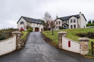 a street with a stone bridge in front of a house at Corlea Studio in Dunwish