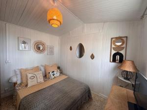 a bedroom with a bed and a lamp at casa serena in Lumio