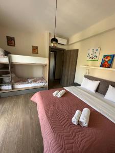 a bedroom with a large bed with two slippers on it at Diana House in Nikiti