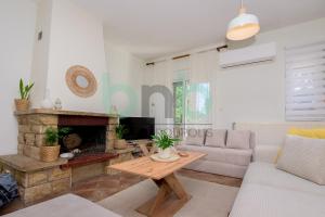 a living room with a couch and a fireplace at Casa Cyra in Alexandroupoli