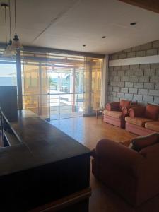 a kitchen and living room with a large counter top at Casa Berenice in Zorritos