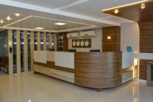 a lobby of a hospital with a reception counter at Hotel Castelo in Gravatal +27 photos