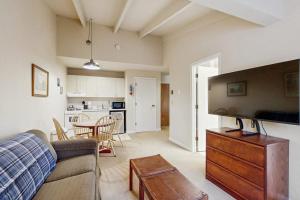 a living room with a couch and a table at Seasons 307 in Warren