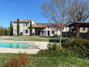 a house with a swimming pool in front of a yard at Villa avec piscine in Soyaux