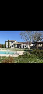 a building with a tree in the middle of a yard at Villa avec piscine in Soyaux