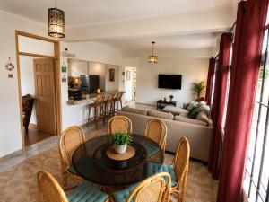 a living room with a table and chairs and a couch at Suntoo Villa Wind & Kitesurf Accommodation in La Gaulette