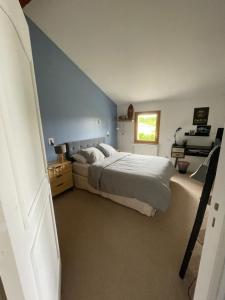 a bedroom with a bed and a blue wall at Villa avec piscine in Soyaux +22 photos