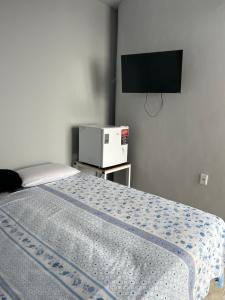 a bedroom with a bed and a flat screen tv at Pousada das Redes in João Pessoa +67 photos