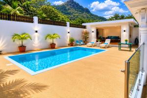 a villa with a swimming pool in a yard at Suntoo Villa Wind & Kitesurf Accommodation in La Gaulette
