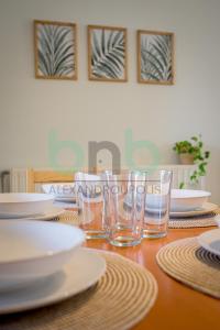 a wooden table with plates and glasses on it at Casa Cyra in Alexandroupoli +43 photos