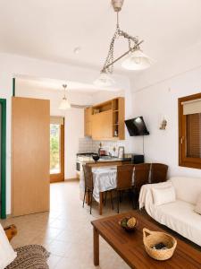 a living room with a couch and a table at Pilgrimos Apartments in Ierissos