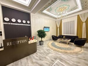 a living room with a couch and a table at Hotel Bogatt in Dushanbe