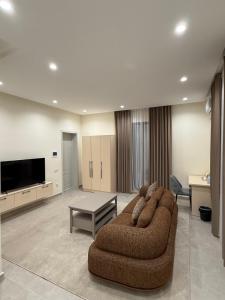 a large living room with a couch and a tv at Hotel Bogatt in Dushanbe +14 photos