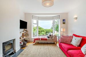 a living room with a red couch and a window at 3 Bed in Felixstowe oc-h32096 in Walton