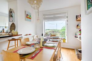 a dining room with a table and chairs and a window at 3 Bed in Felixstowe oc-h32096 in Walton