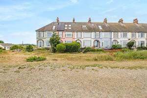 a large house on a hill with a yard at 3 Bed in Felixstowe oc-h32096 in Walton