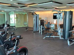 a gym with several exercise bikes and a television at Novotel Recife Marina in Recife