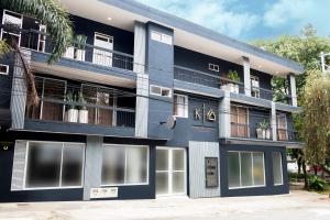 a blue building with a lot of windows at Komfort House Premium in Medellín