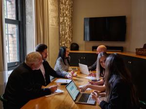 a group of people sitting around a table with laptops at Hotel Woolstore 1888, Sydney - Handwritten Collection in Sydney