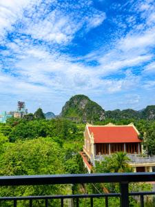 a building with a red roof on top of a hill at Tam Coc Sylvani Homestay in Vũ Lâm