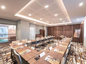 a large room with long tables and chairs at Mercure Achères St Germain en Laye in Achères