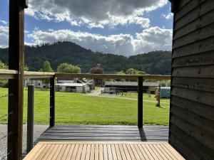 a wooden porch with a view of a field at Tower Farm Holidays - Glamping in Llangollen