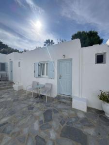 a white building with a table and chairs at Casa Bianca in Ornos