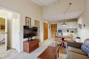 a living room with a couch and a table at Seasons 308 in Warren