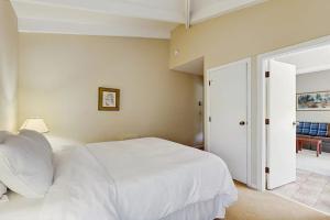 a bedroom with a white bed and a sliding glass door at Seasons 308 in Warren