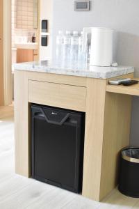 a kitchen island with a black dishwasher under a counter at Cheng House in Yuchi
