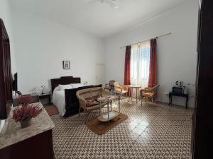 a living room with a bed and a table and chairs at La Almedina: Palacio de Foronda in Cazorla +66 photos