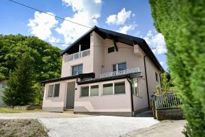 a white house with a black roof at Villa NOA in Jajce